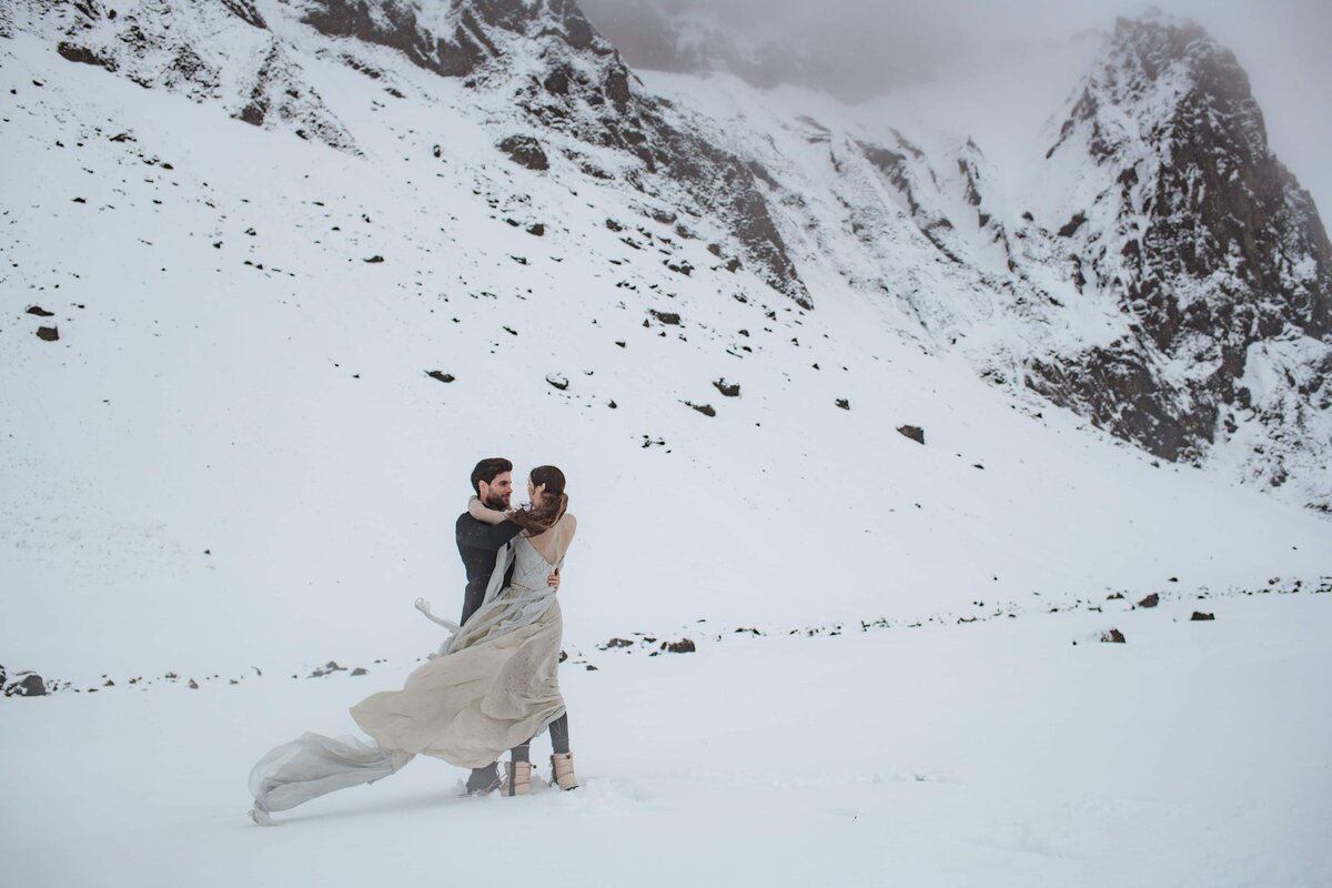 Couple sharing a kiss in a snowstorm in Vik, Iceland