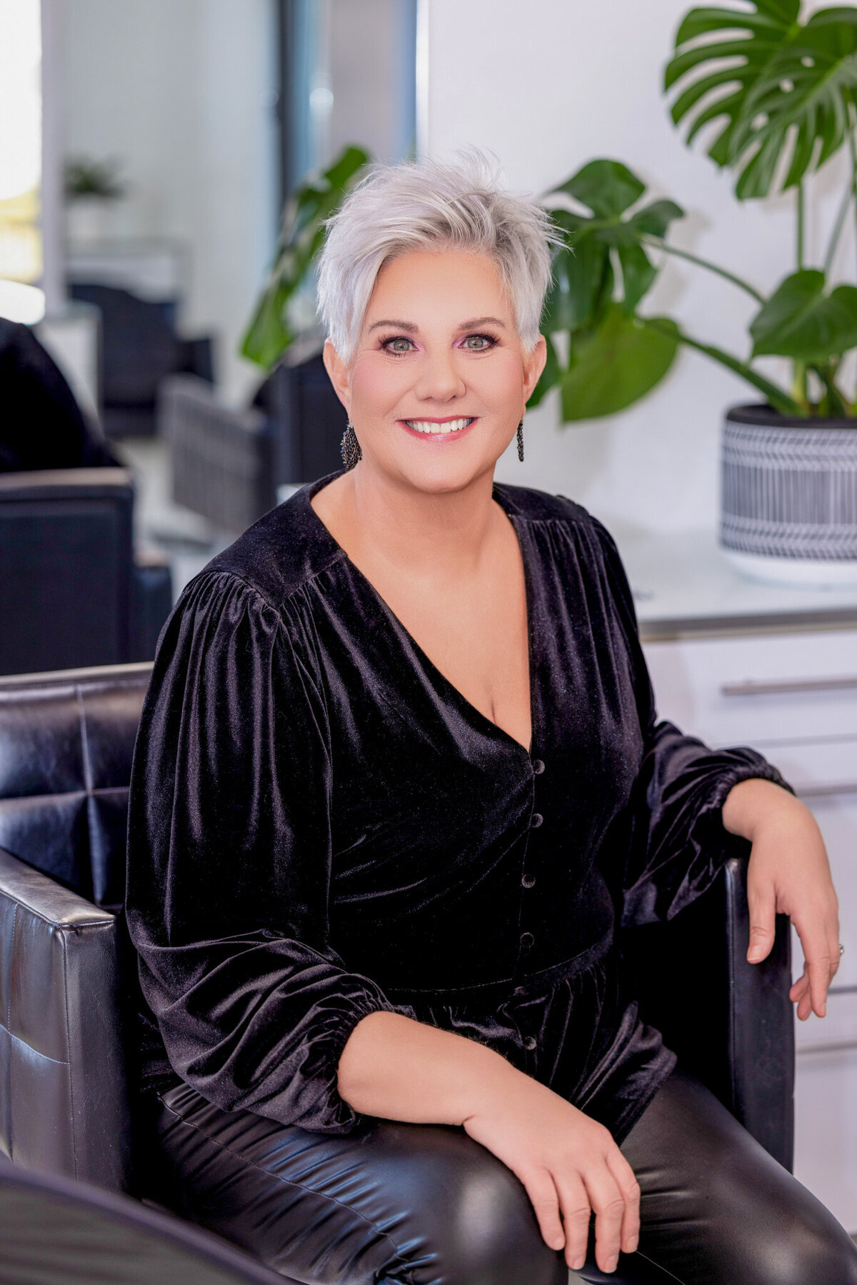 A modern, empowering portrait of a salon owner, showcasing confidence, expertise, and high-end beauty branding.
