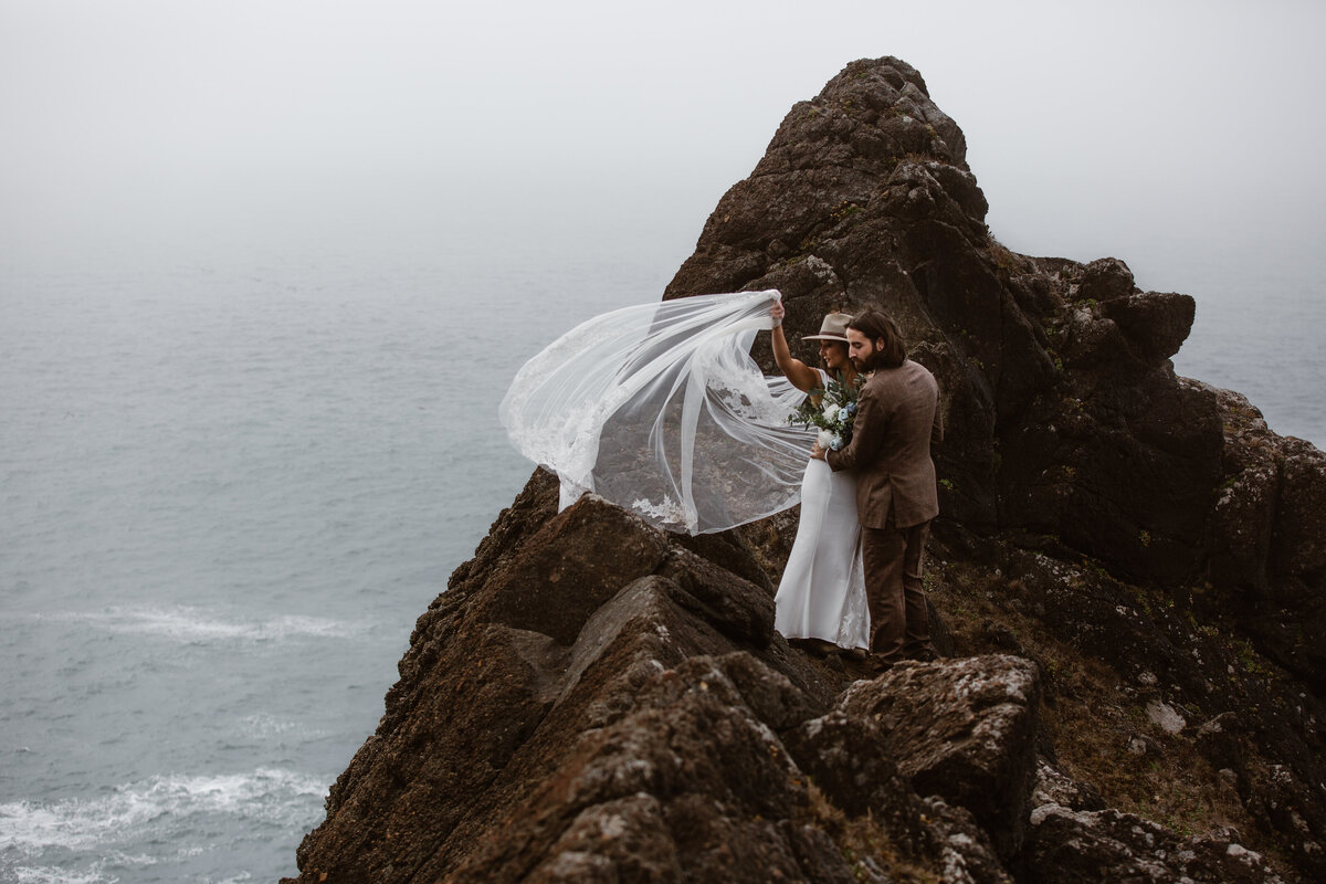 bride and groom on rock