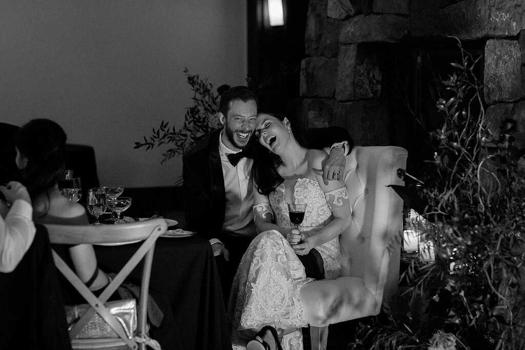 Bride and groom laughing at reception by Court Amber Photography, joyful and adventurous wedding photographer in Calgary, Alberta. Featured on the Bronte Bride Vendor Guide.