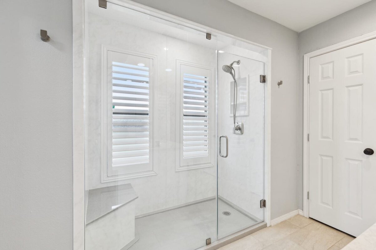 10216_shadow_way_dallas_tx_primary_bathroom_walk_in_glass_shower_with_bench_and_rainfall_head_haven_realty_group