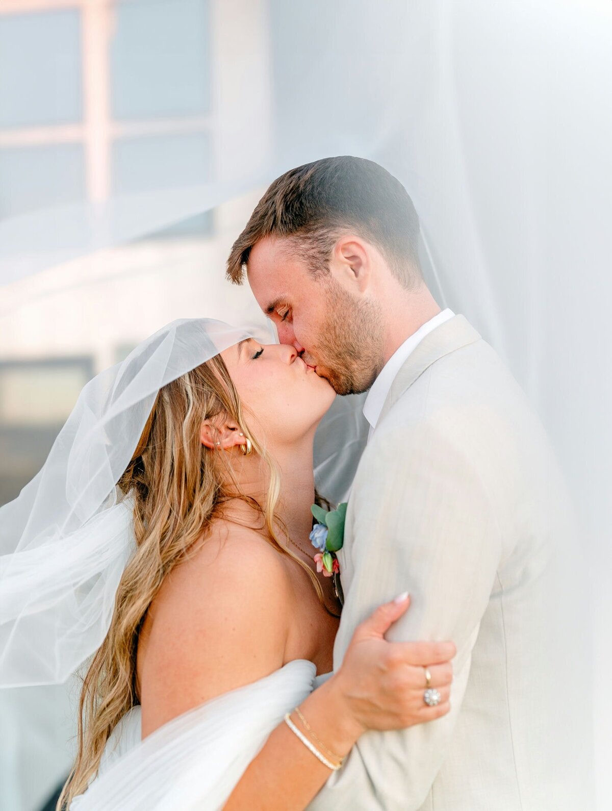 Couple-Kissing-Under-Veil