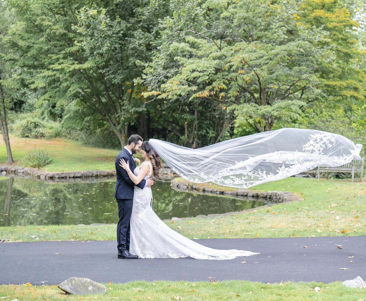 Bride and groom veil blowing in the wind