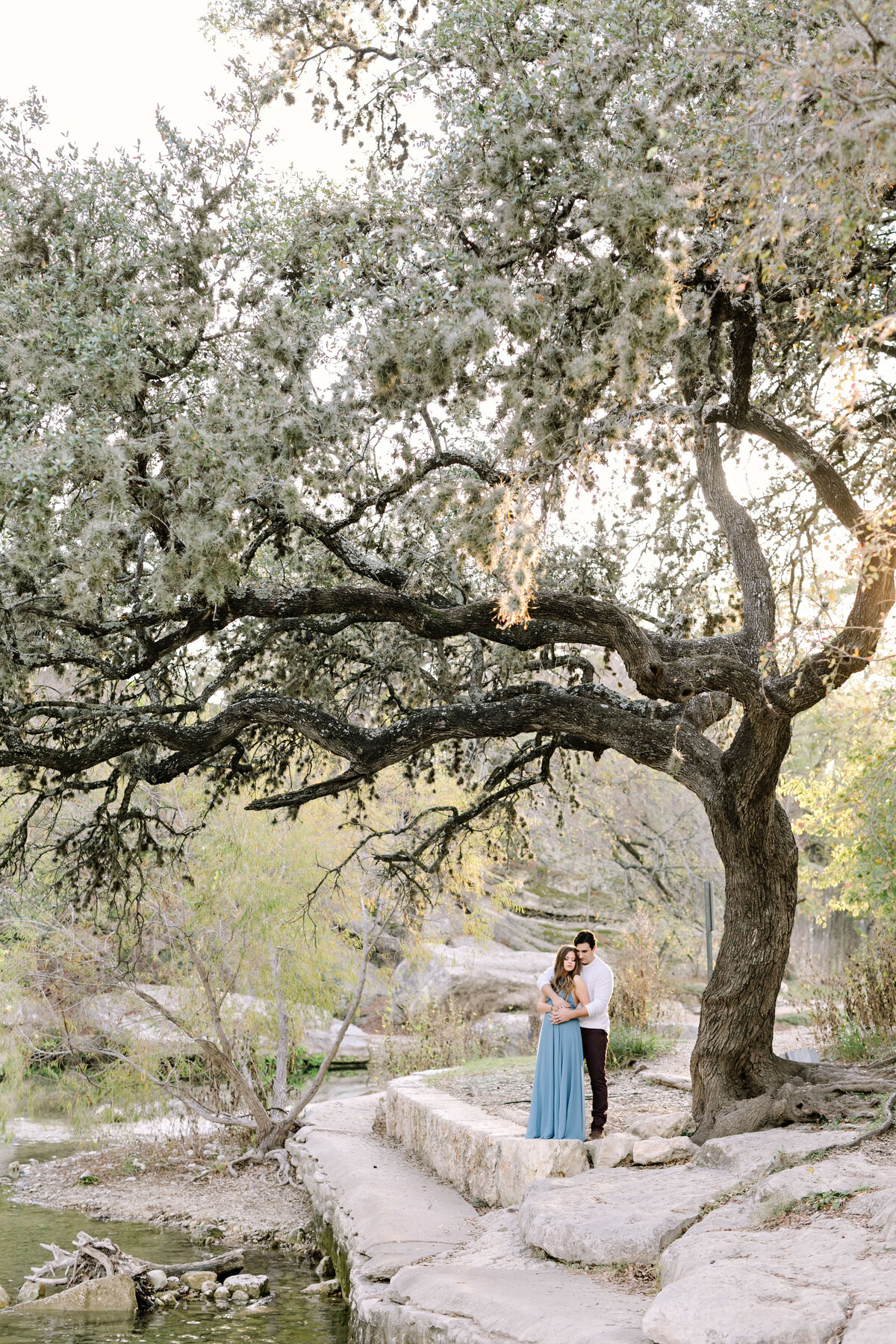 Woman in a dusty blue dress for her engagement session