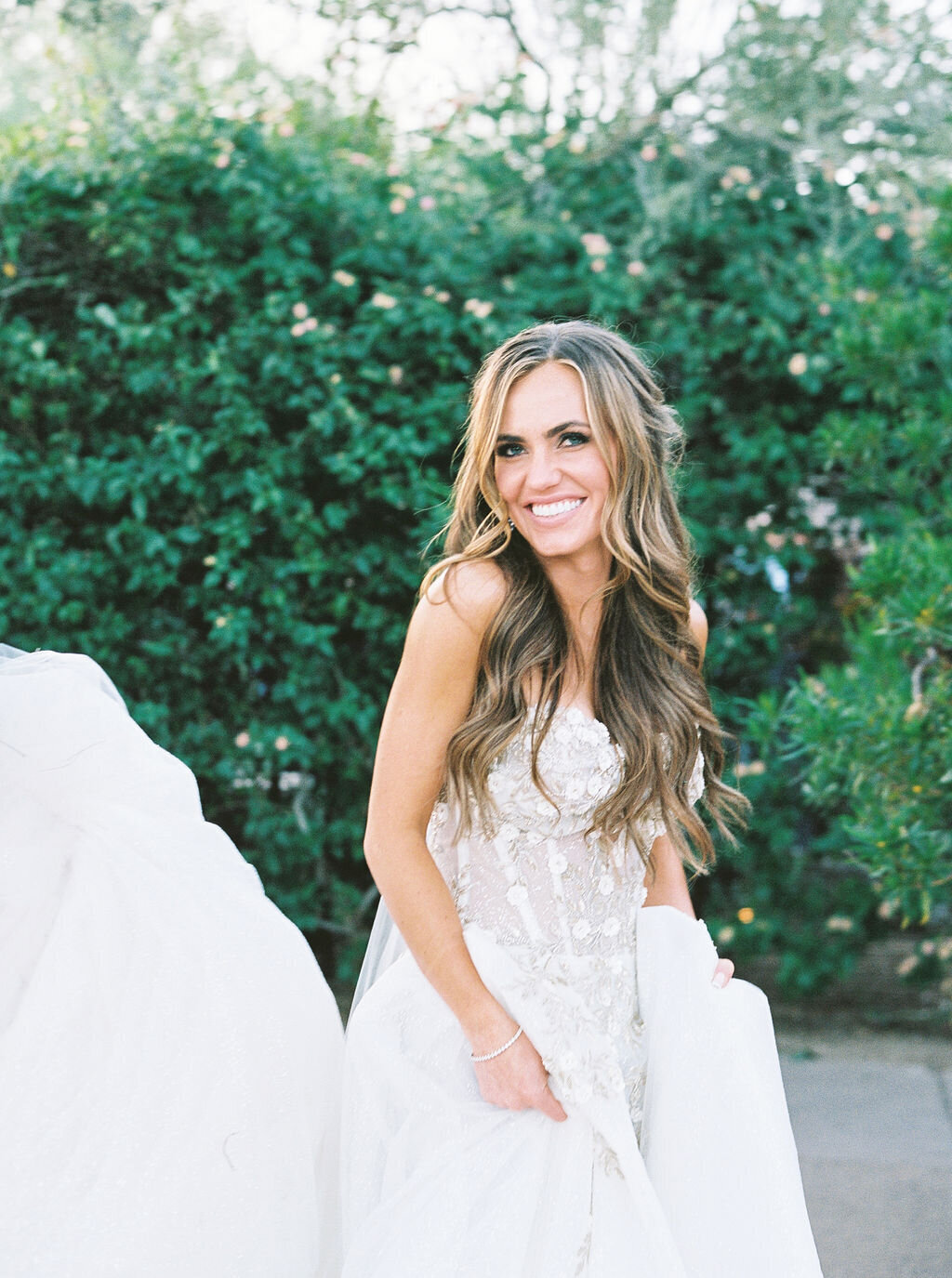 A joyful bride captured in a candid moment, wearing a breathtaking lace wedding gown. The perfect bridal portrait showcasing happiness and elegance.