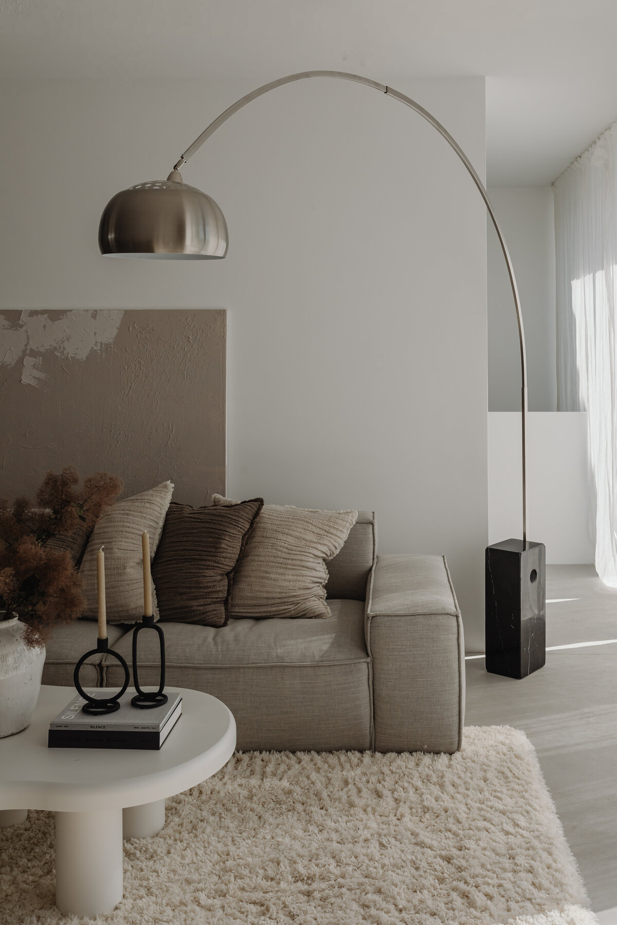 Modern living room with arched floor lamp