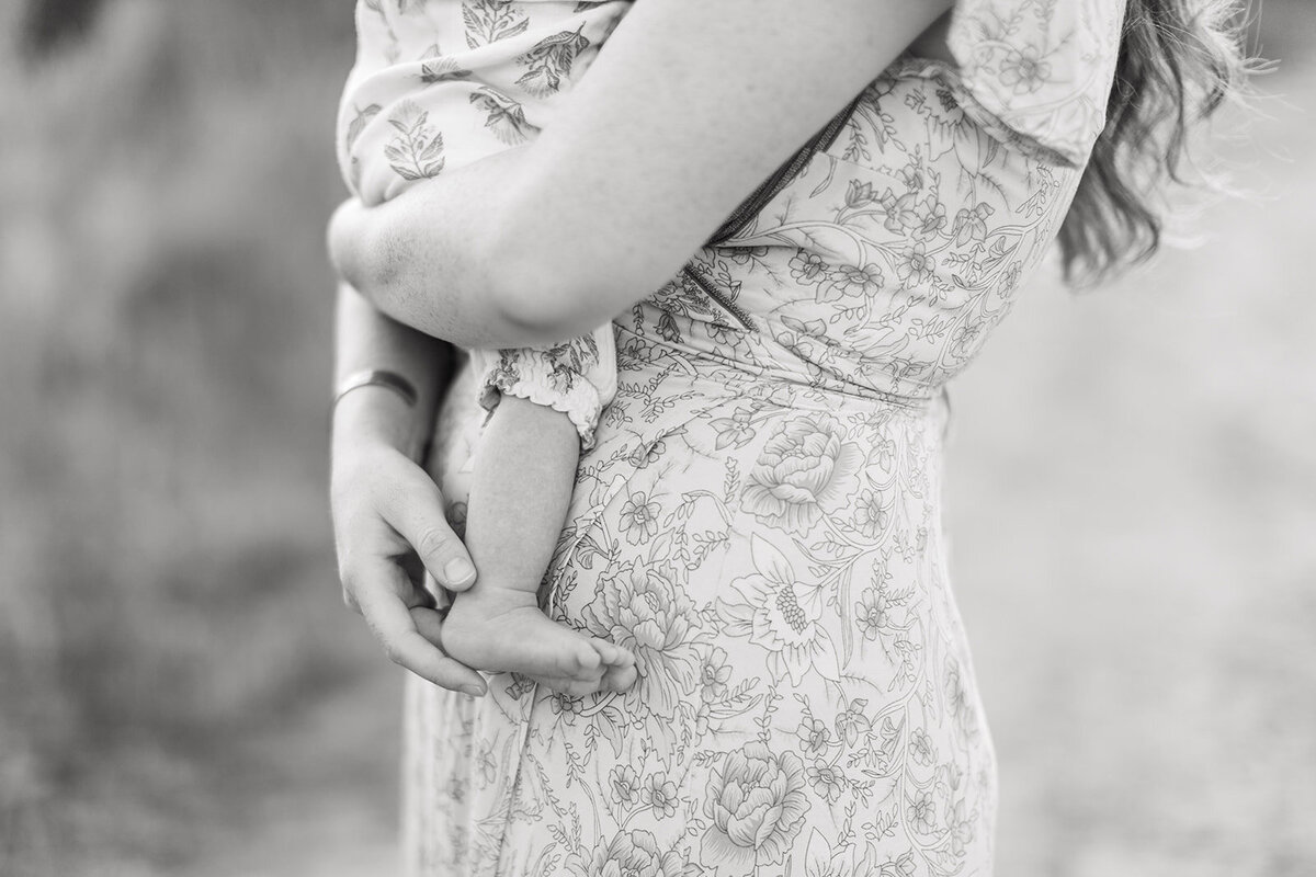 Mom holding baby during family session in golden light