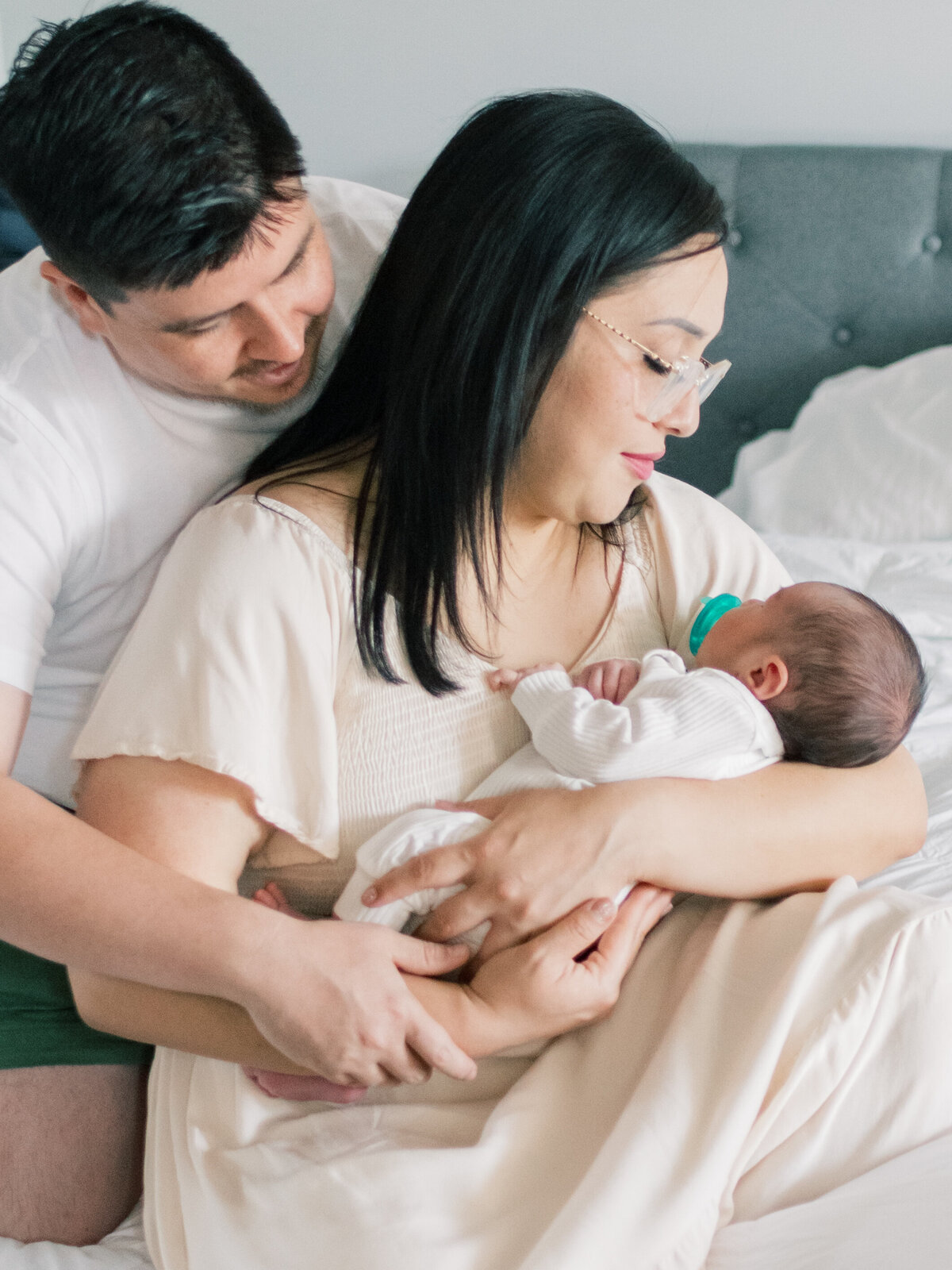 Dad and Mom looking at newborn baby boy.