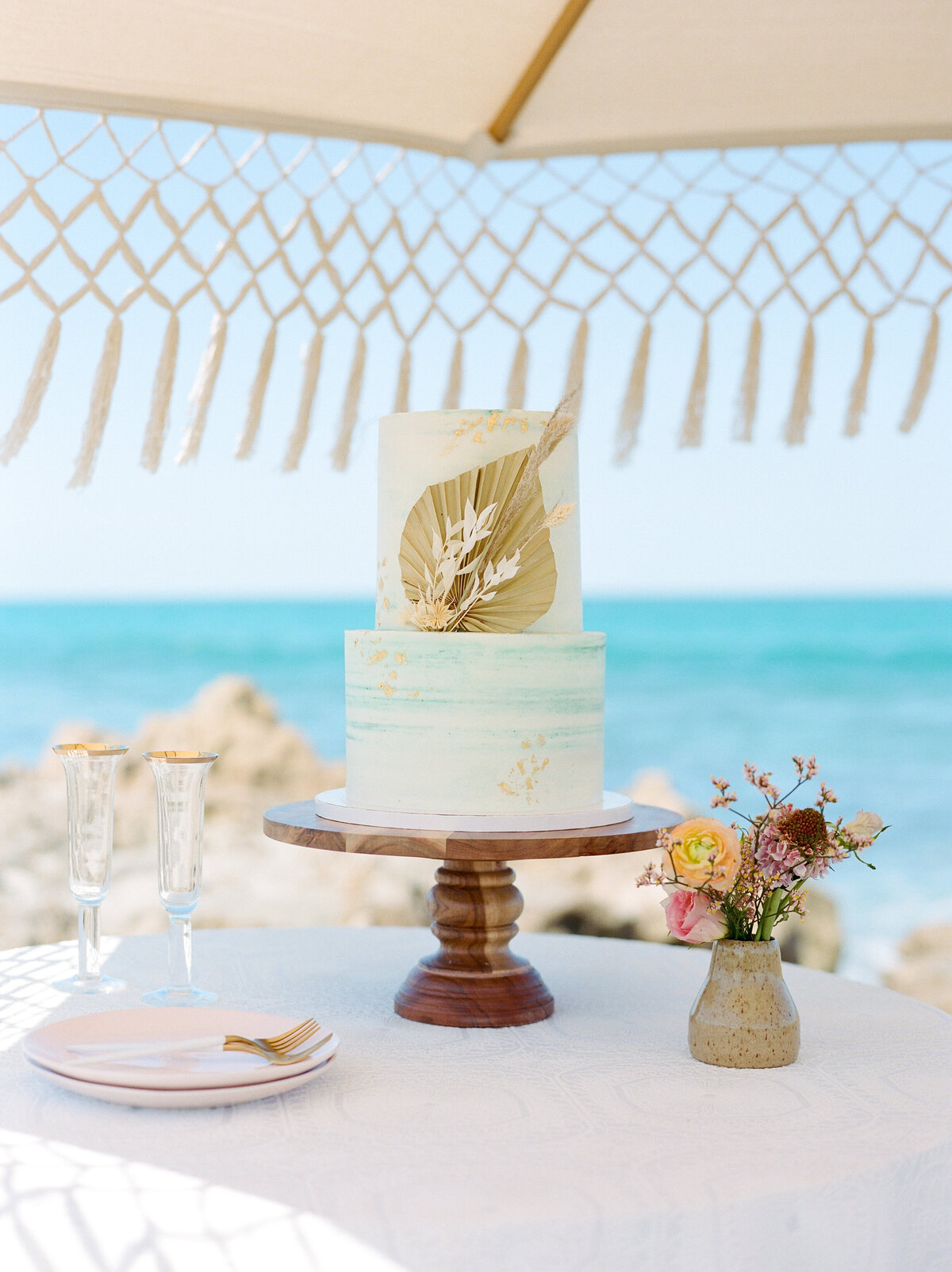 Shot of dainty florals and a wedding cake.