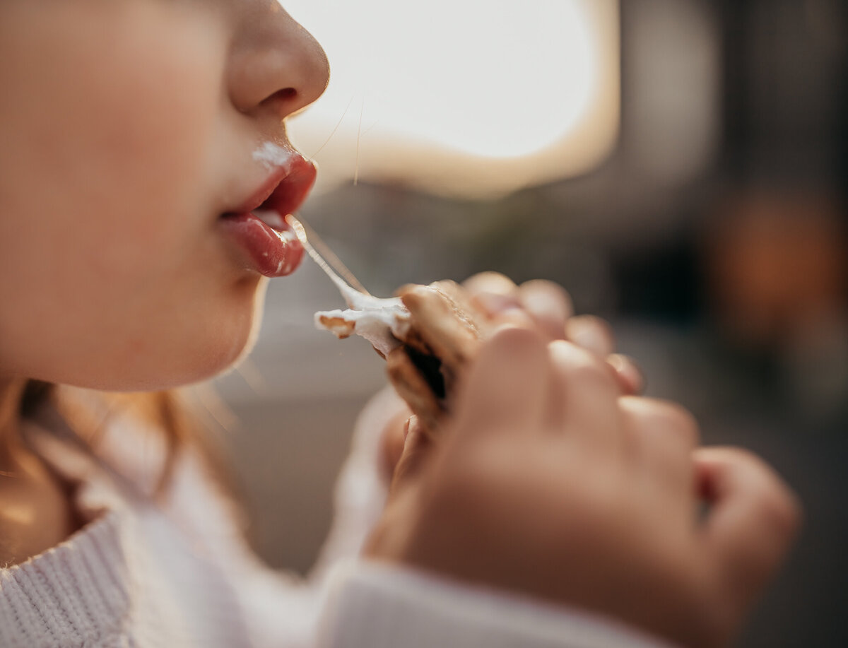 girl eating smore