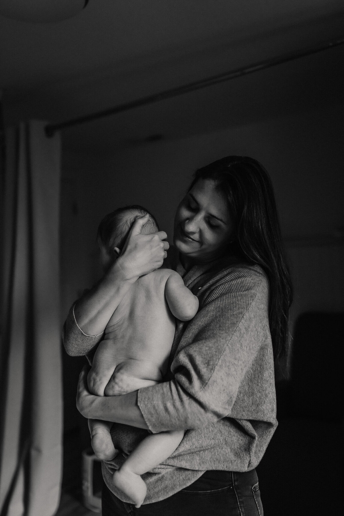 San Francisco mom snuggles baby after bath time at in home family photography session