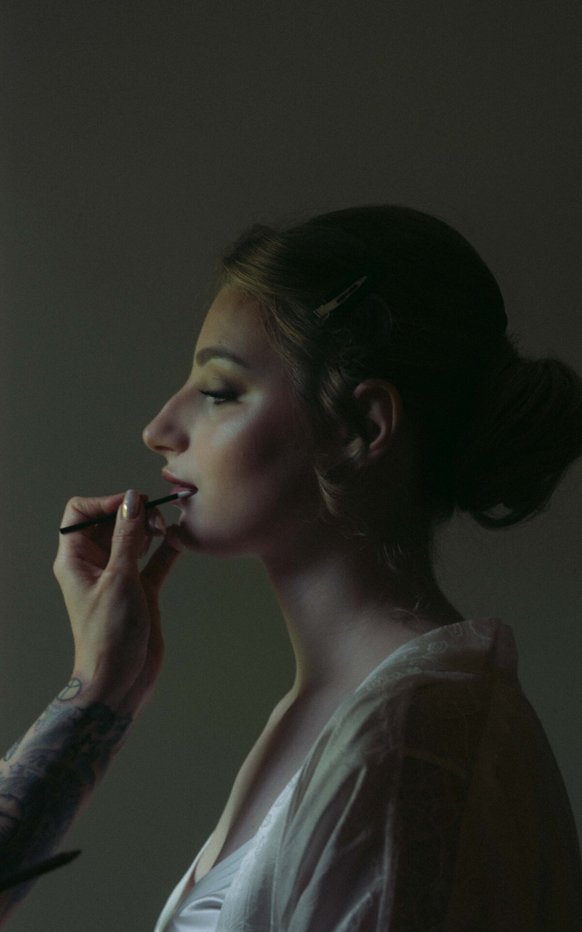 Delicate moments of a bride preparing for her wedding day captured in beautiful photography.