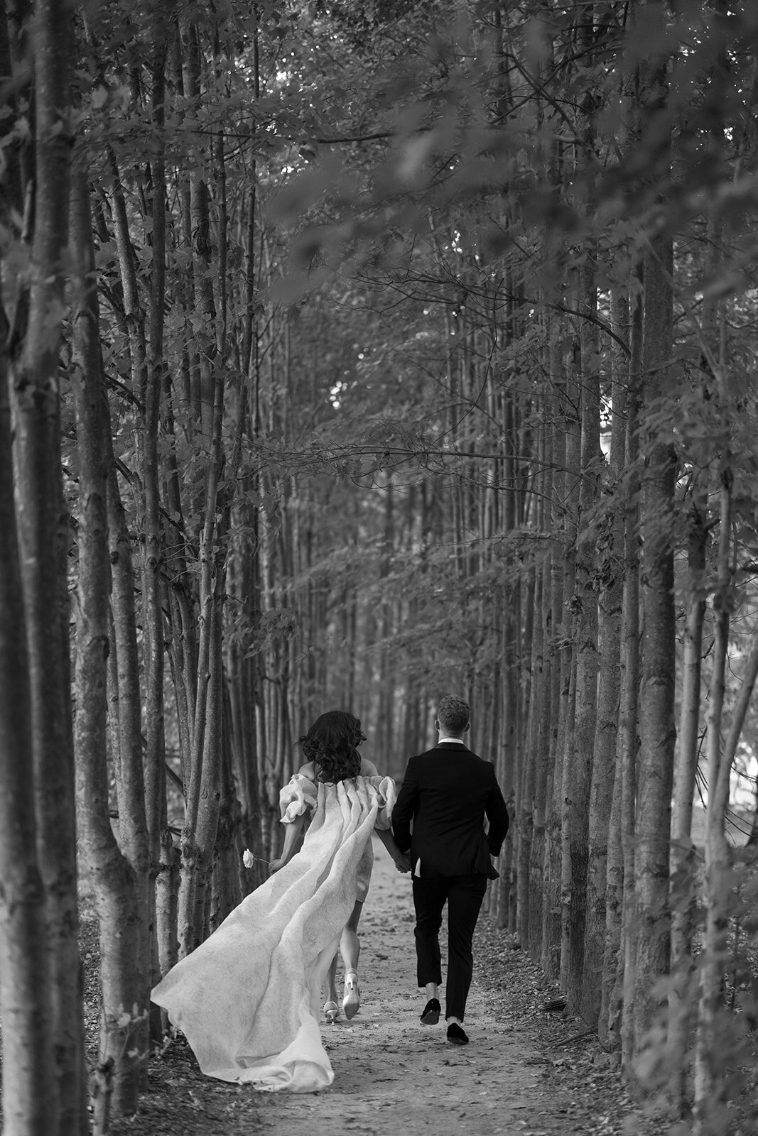 A couple runs away at the Grounds for Sculpture in New Jersey