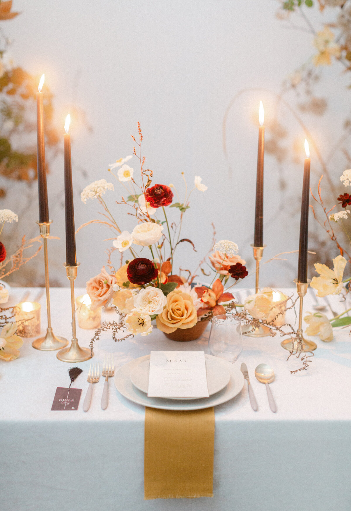 An organic centrepiece of orange flowers on an elegant table at Le Livart.