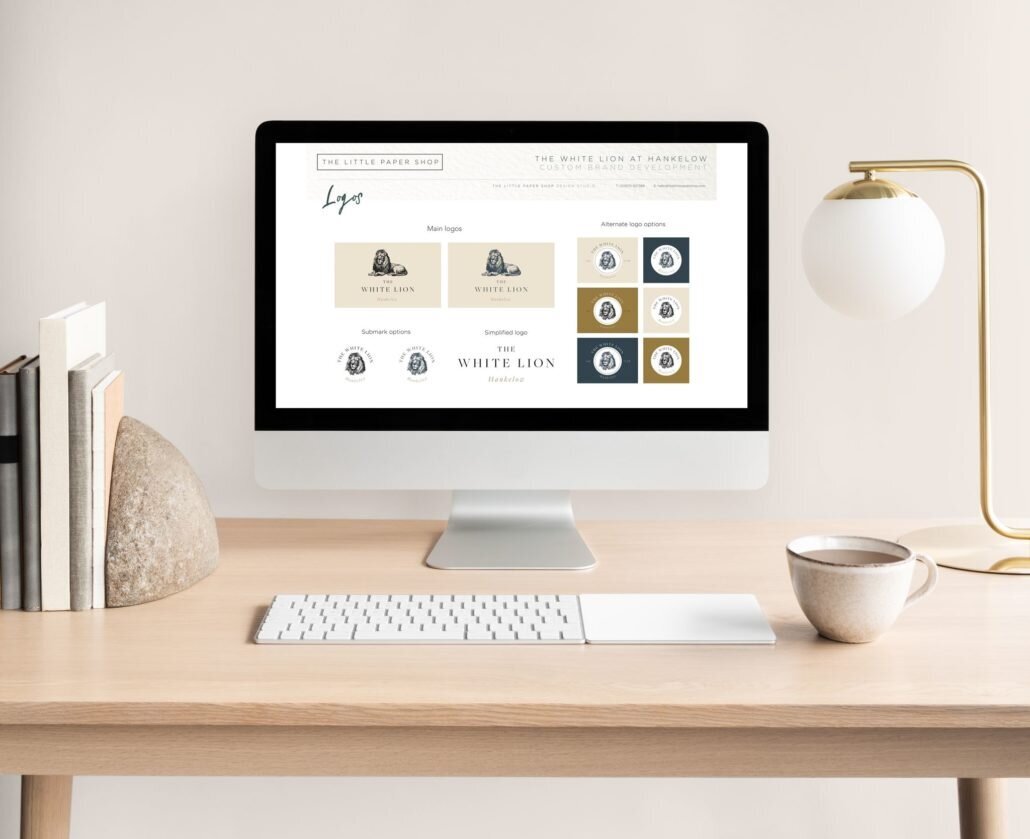Laptop showing branding designs created for The White Lion