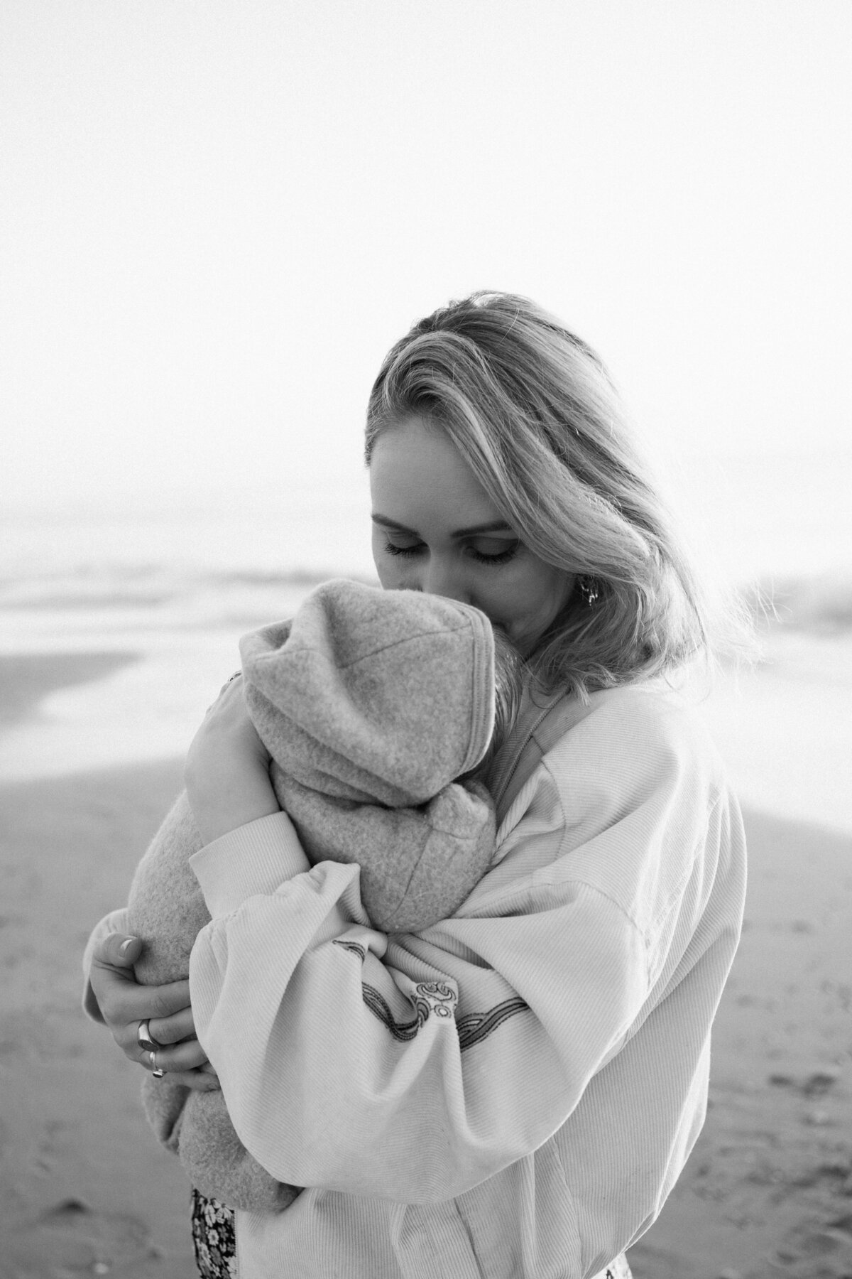 Newborn fotografie van een baby van enkele weken oud, vastgelegd in huis en aan zee. Intieme momenten van een pasgeboren baby, vol met de heerlijke chaos van het gezinsleven.