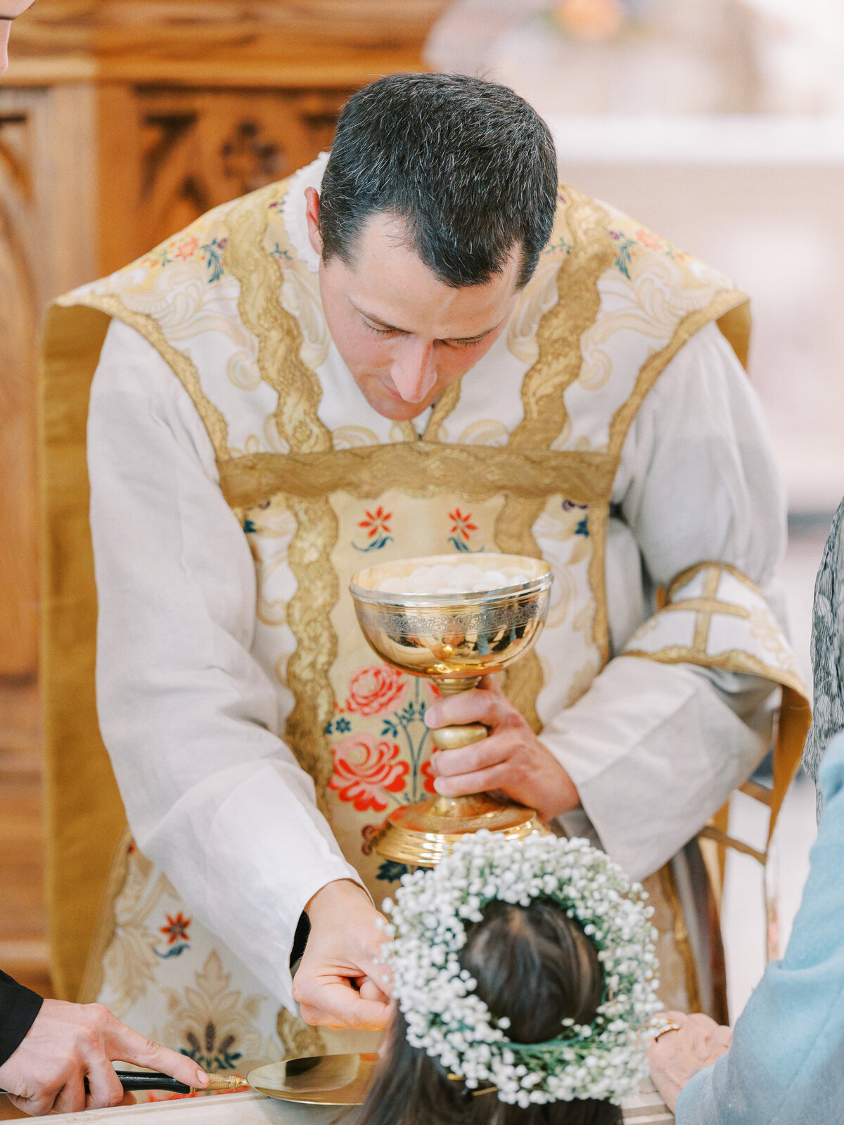 Bride taking Eucharist during traditional Latin Mass wedding at Our Lady of the Assumption Church in Walton, KY