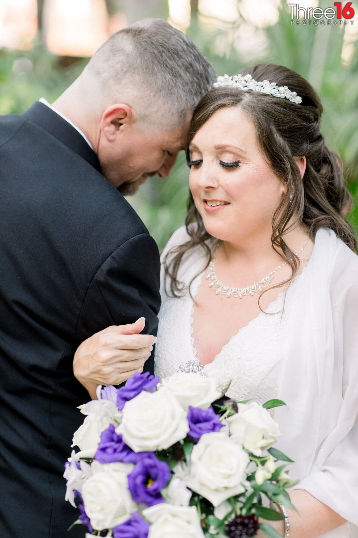 Tender moment as Groom's head touches Bride's head