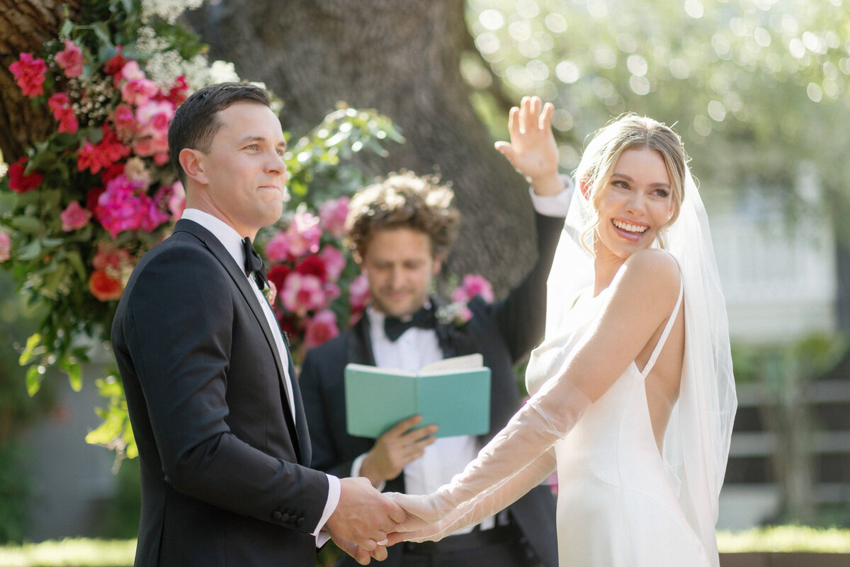 bride and groom holding hands at wedding ceremony