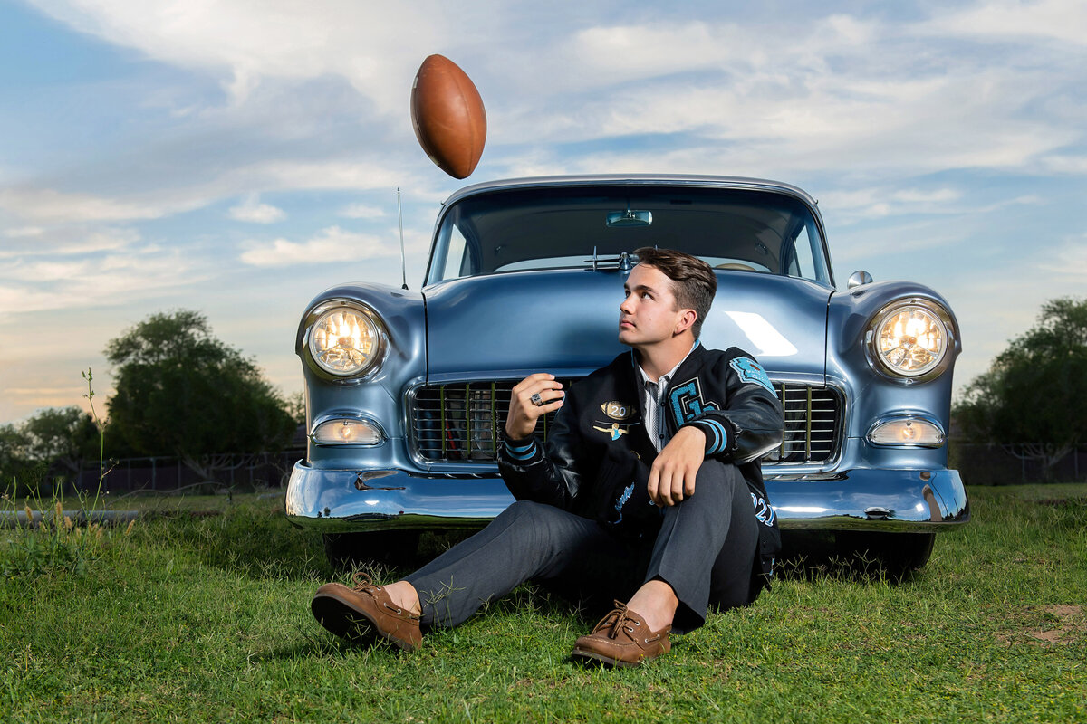 senior guy with football and vintage car
