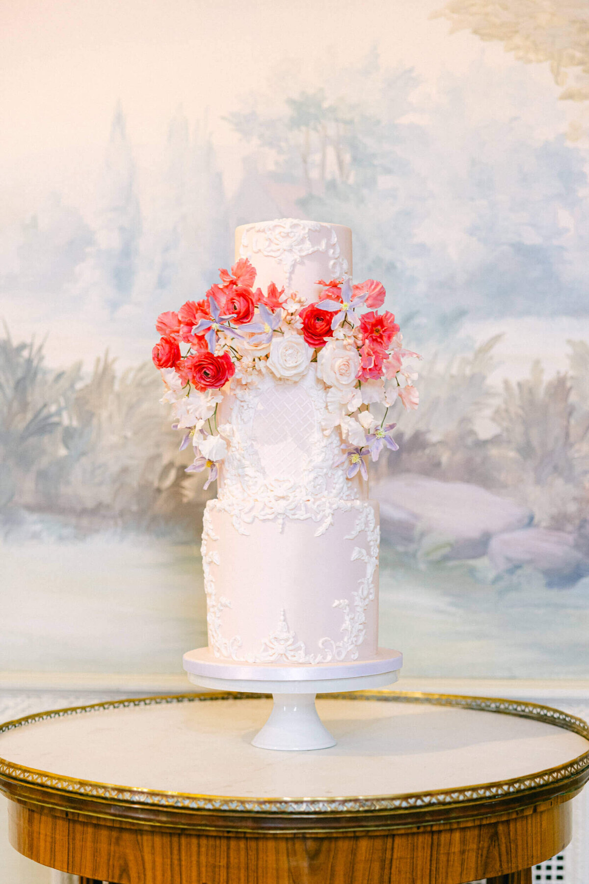 A wedding day photo of the couples white wedding cake at Hedsor House in  the UK