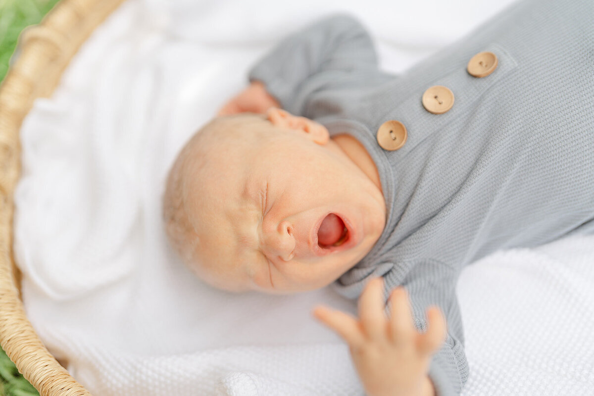 baby yawning during outdoor newborn picture in Centreville, VA