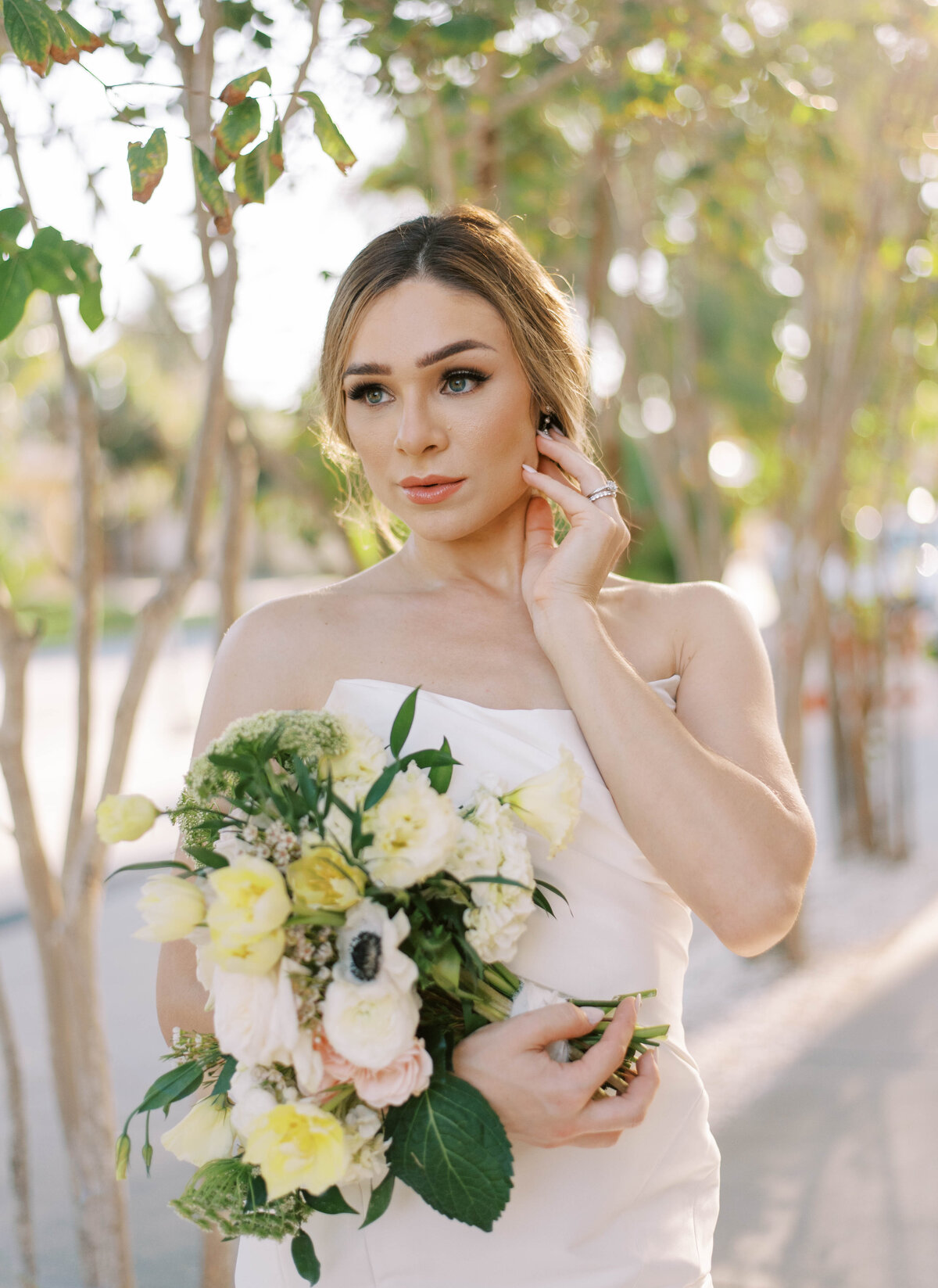 bridal portraits with strapless wedding gown holding greenery and white bouquet