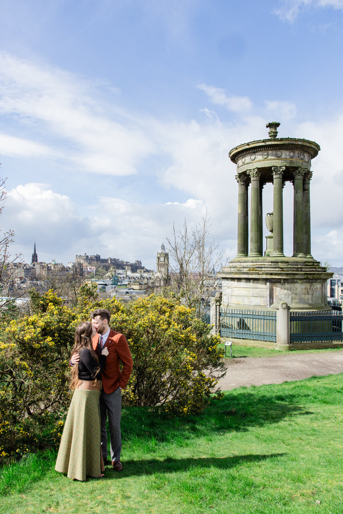 bride kisses groom on Calton Hill