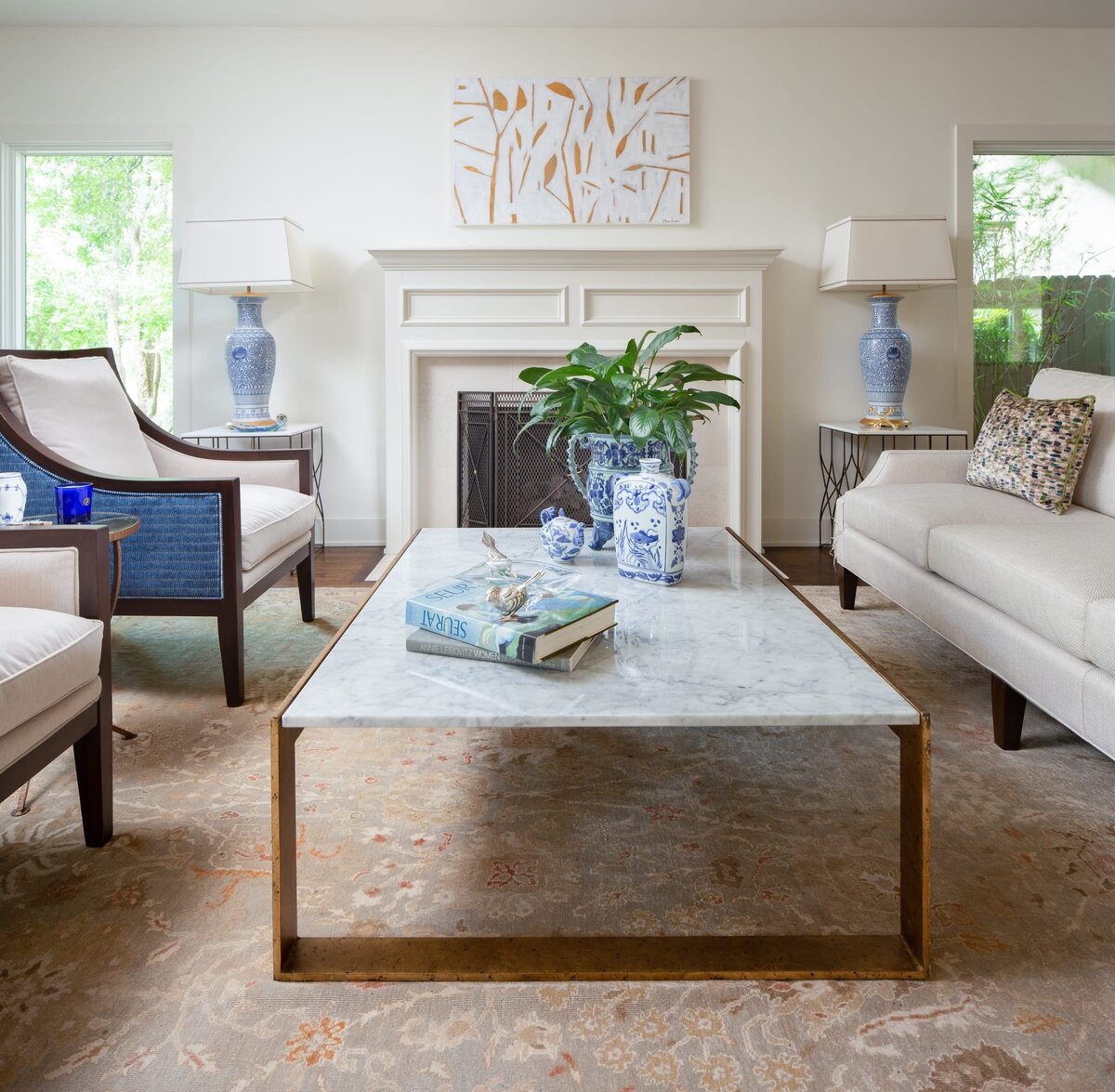 the keeping room interiors grant marble coffee table with books on table green plant