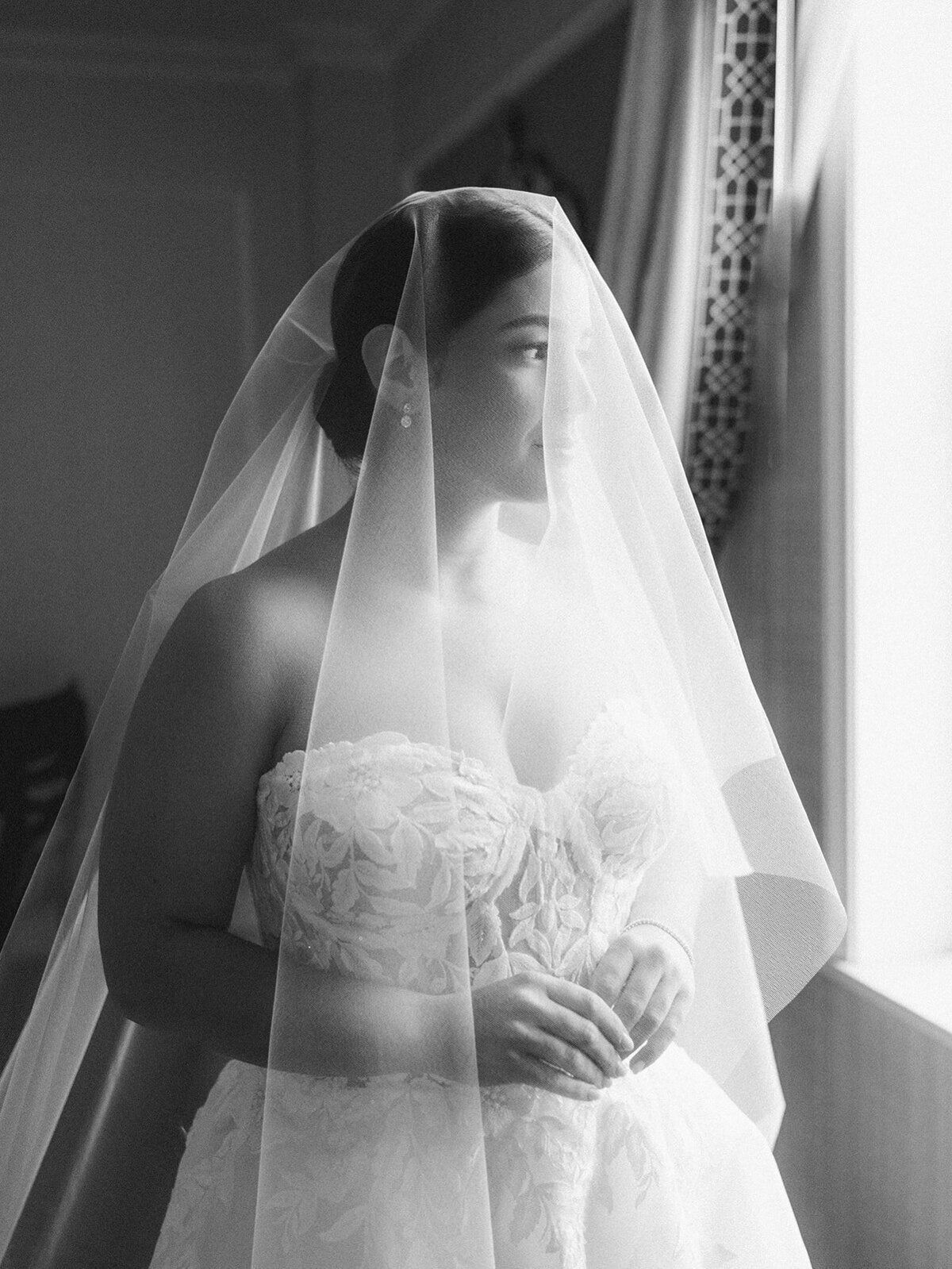 Bride portrait gazing out of window