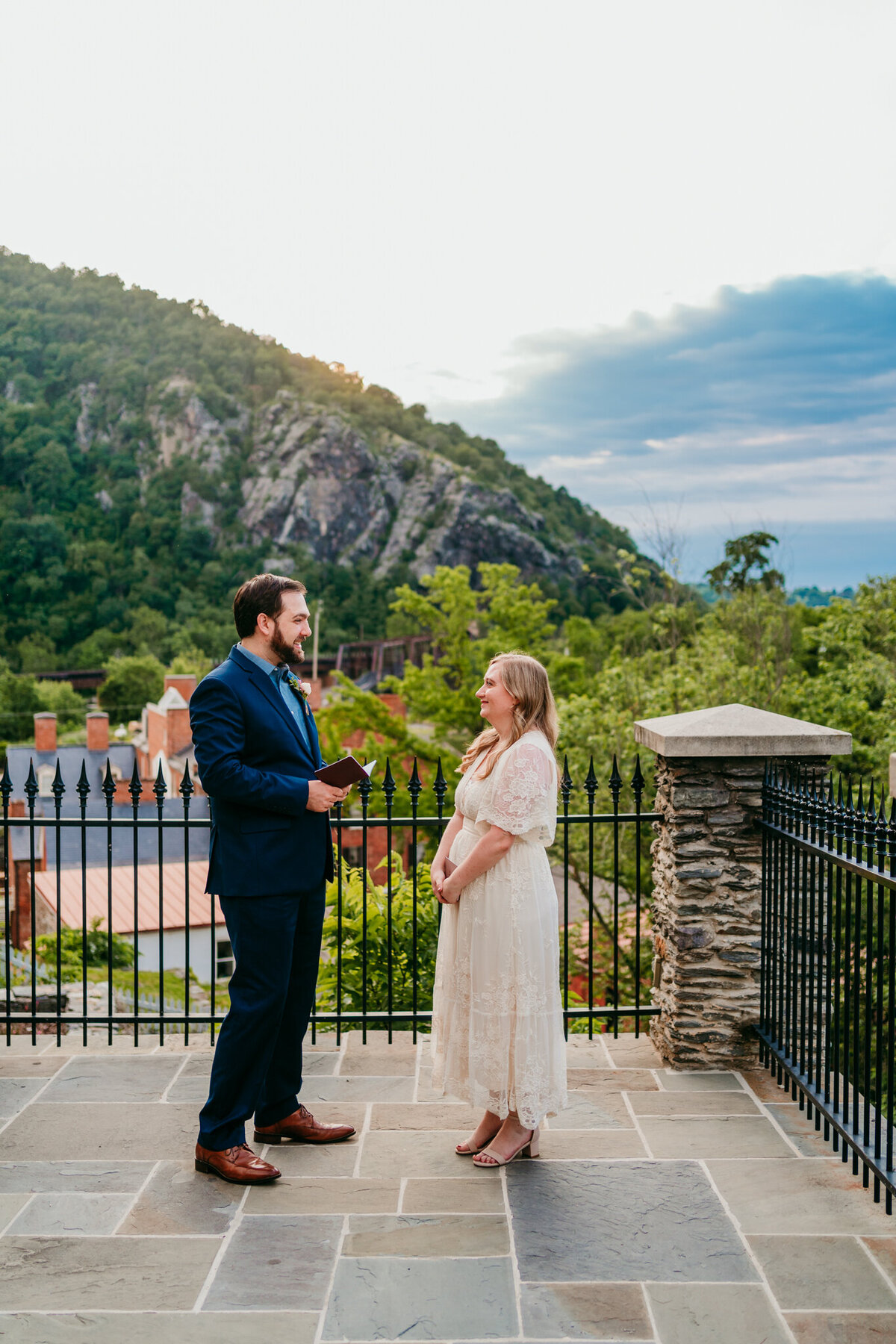 Couple exchanging vows at mountaintop overlook with blue hour skies