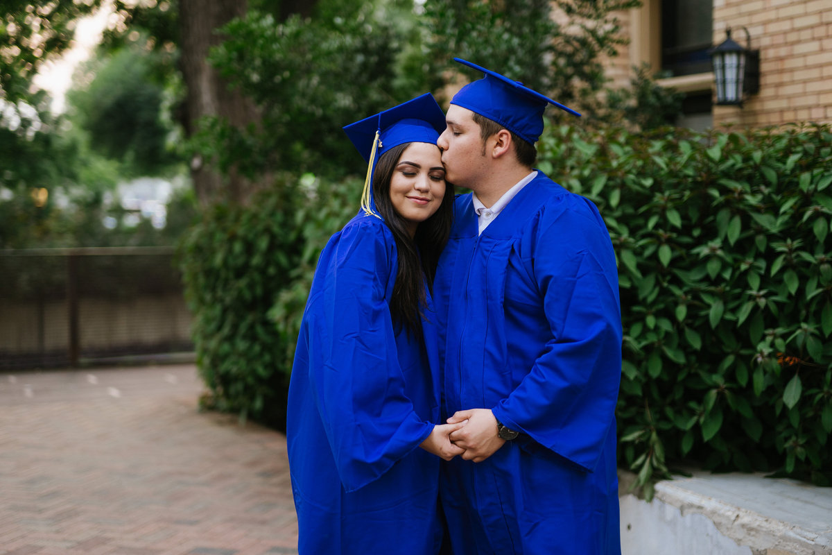 high school senior couple sweethearts kissing forehead by San Antonio senior photographer