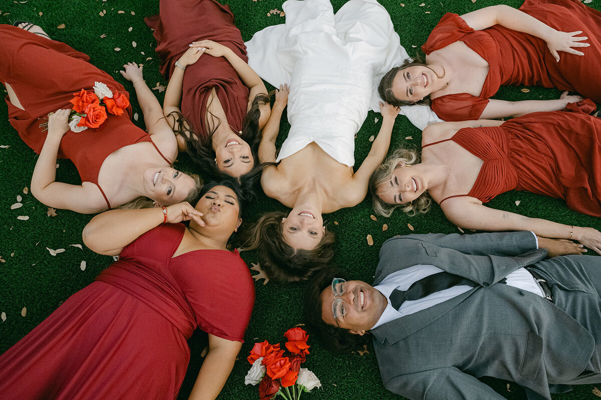 Editorial image of bridesmaids laughing and lounging in luxury wedding party photo in Texas