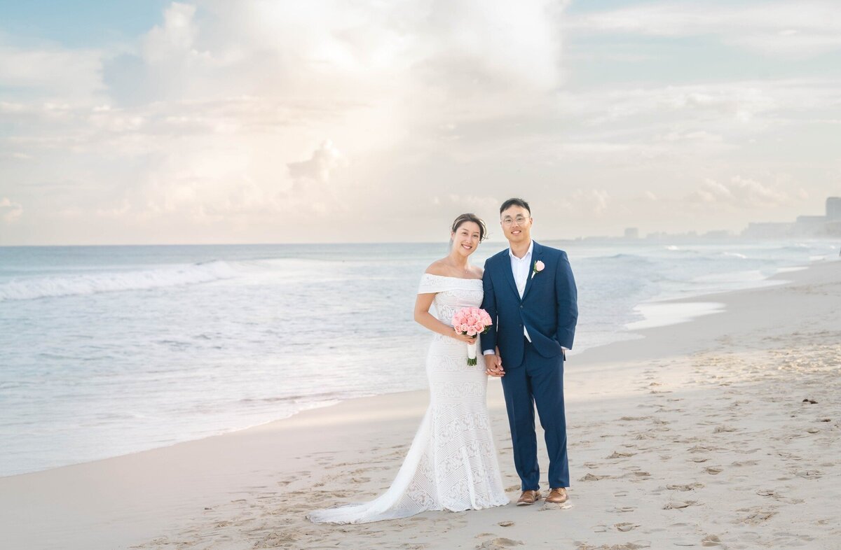 a bride and groom on the beach in Cancun