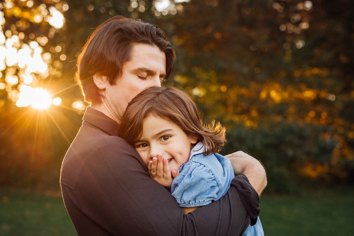 father kissing daughters head