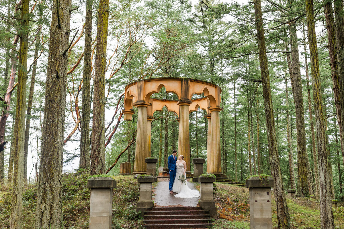 Roche-Harbor-wedding-venue-on-San-Juan-Island-with-couple-in-woods-in-Game-of-Thrones-Mausoleum-set-photo-by-Joanna-Monger-Photography
