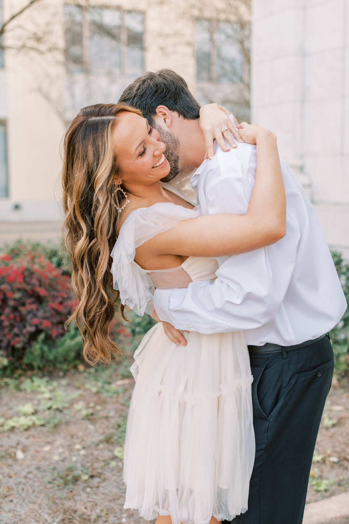 A couple shares an intimate moment for their spring engagement photos.