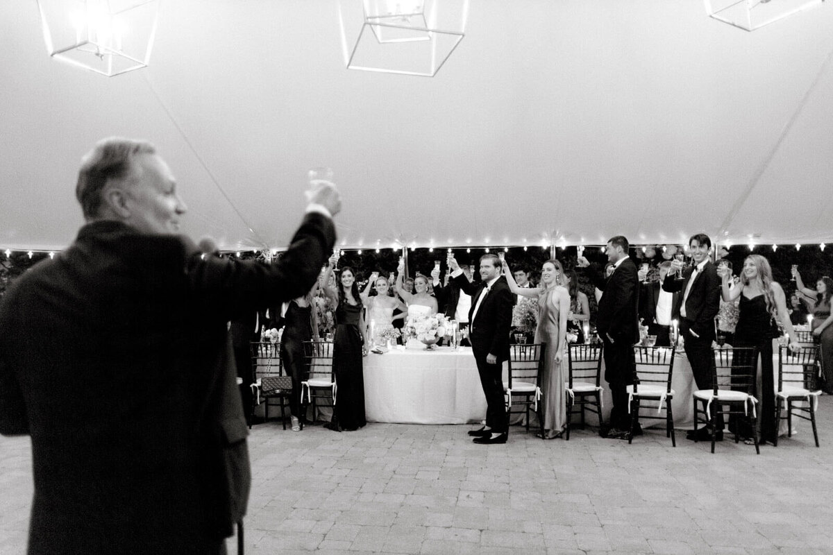 The guests are doing the wedding toast at the elegant wedding reception at Lion Rock Farm, CT. Image by Jenny Fu Studio