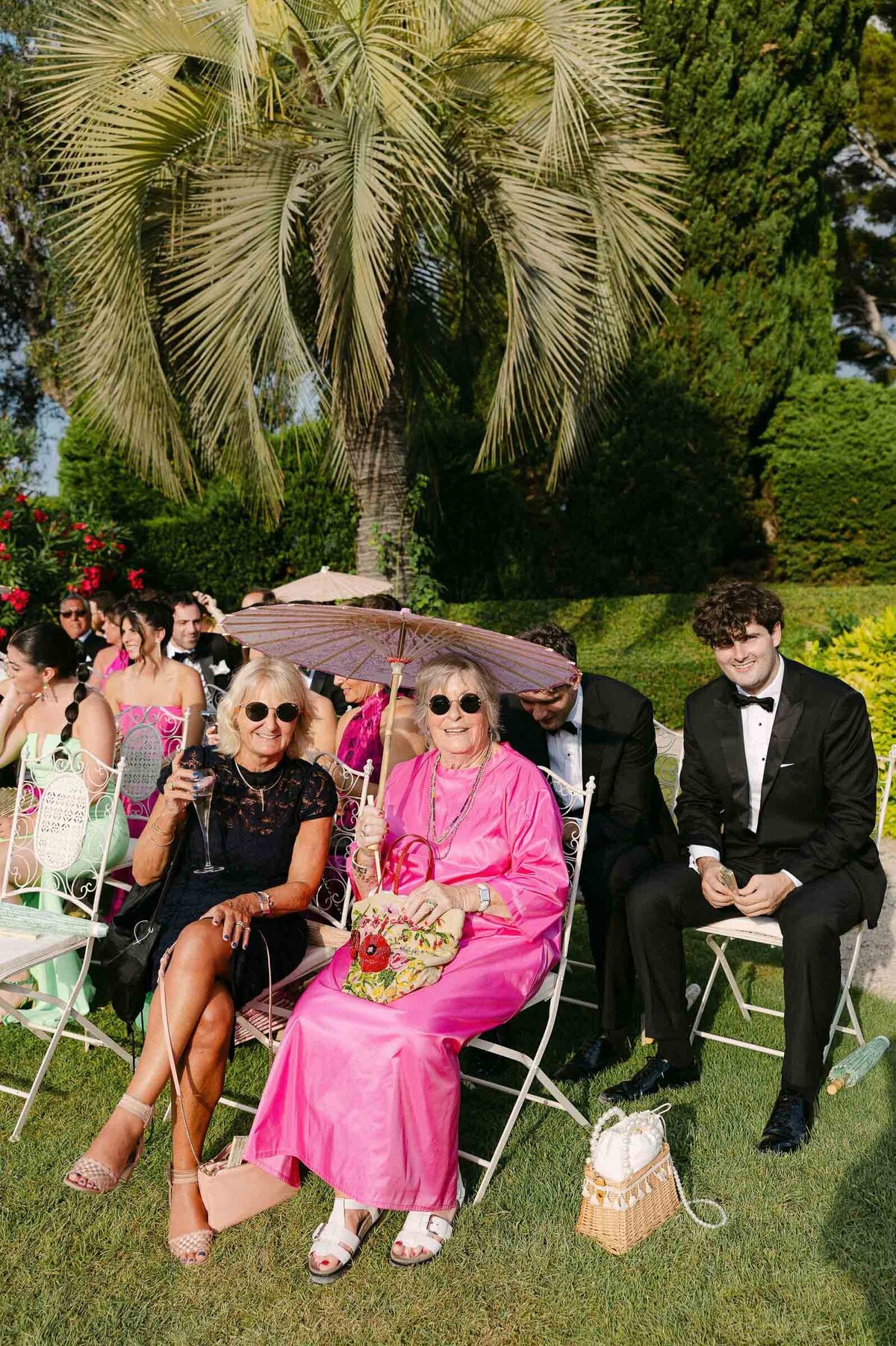 Guests sitting during the wedding ceremony in formal attire.