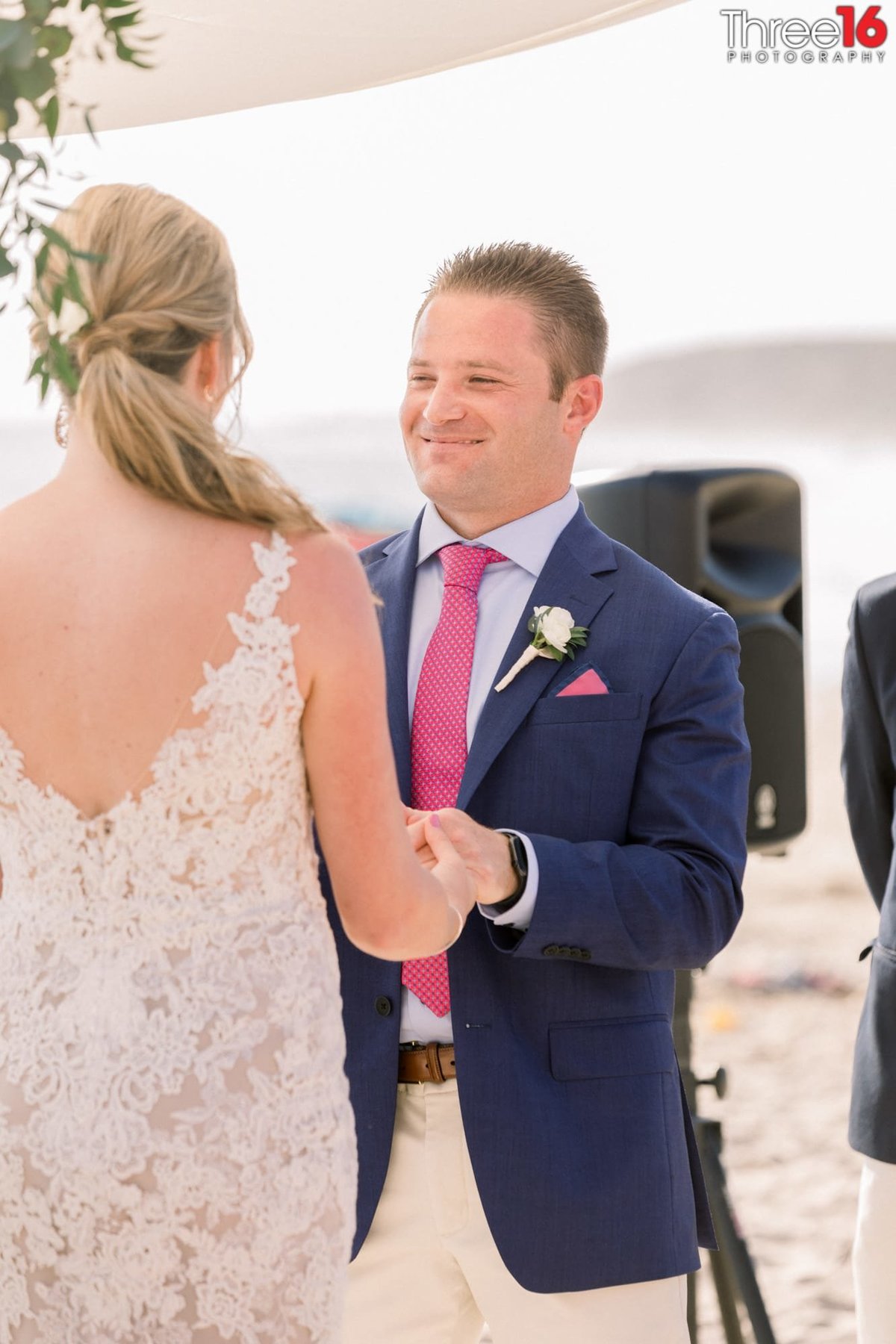 Groom looks at his Bride and smiles