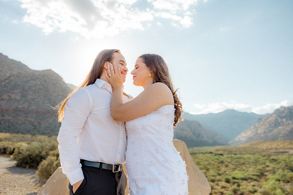 Engaged couple where the girl holding guy's face in Nevada