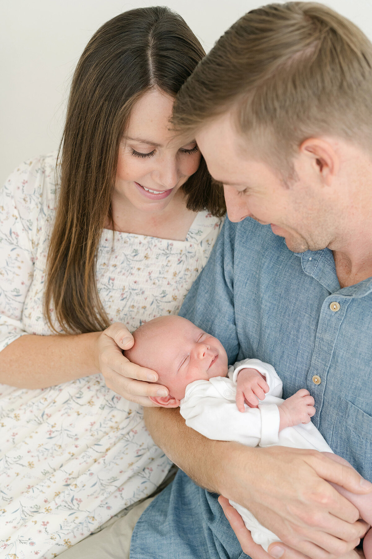 Louisville Ky newborn baby smiles at parent during photo shoot with Juile Brock