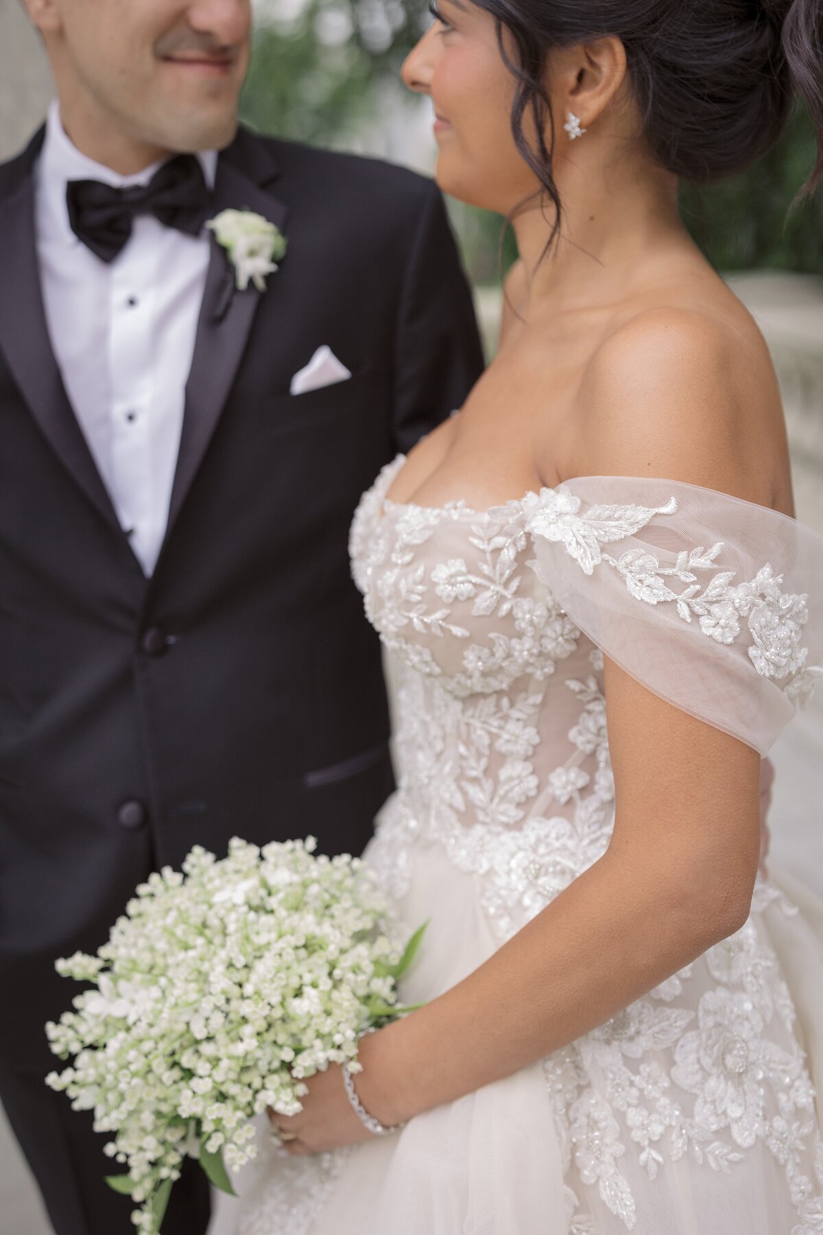 Close up detail of off the shoulder wedding gown.