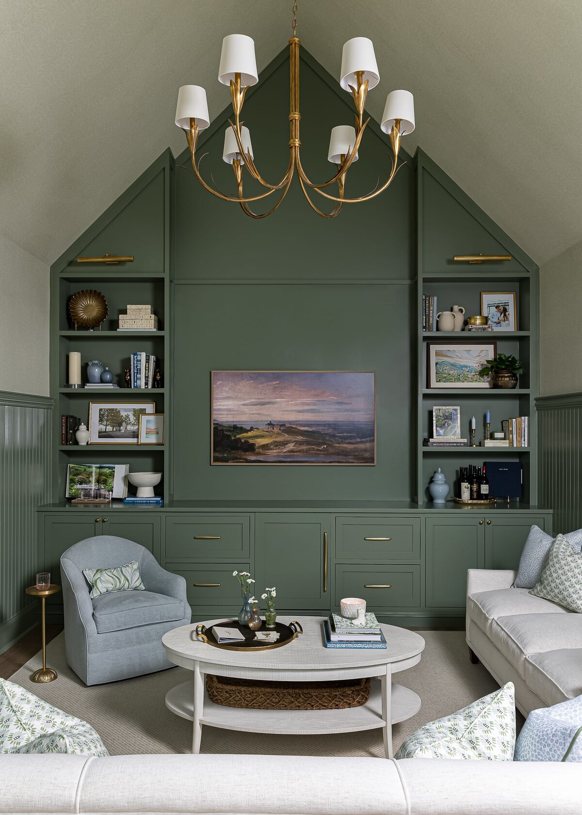 melinda chesson interiors carriage house sitting area with vaulted ceilings and gold lightfixture with green walls