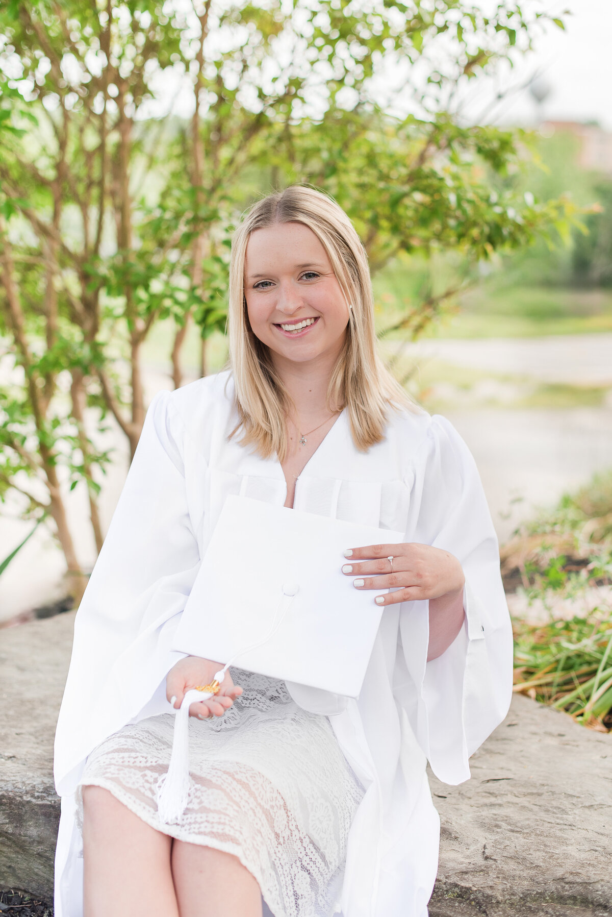 high school senior in white cap and gown