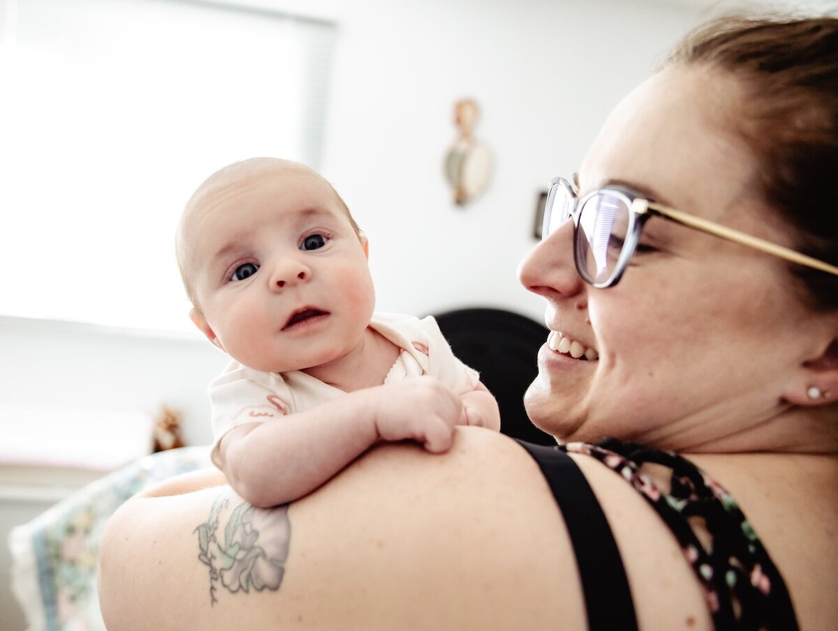 A new mama holds her 2 day old baby in her arms
