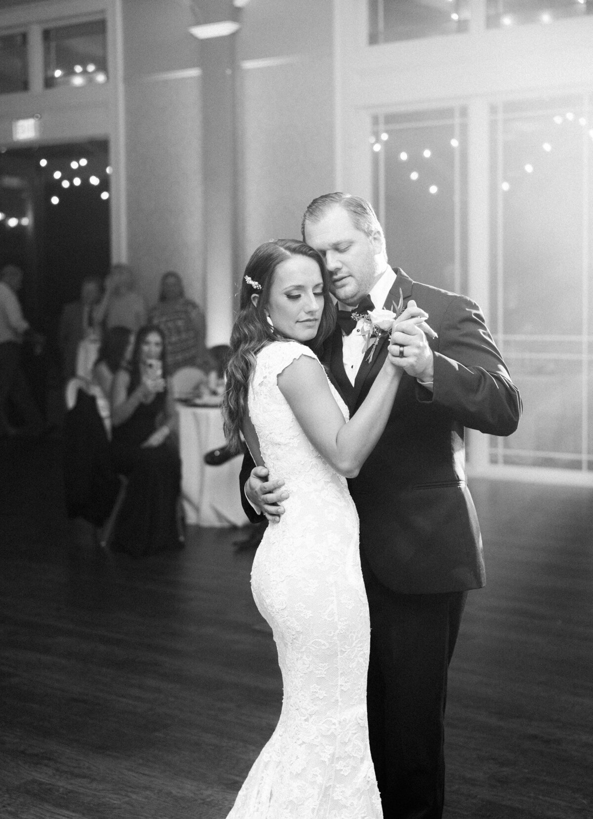 A bride and groom share an intimate first dance in black and white by Huntsville wedding photographer, Kelsey Dawn Photography