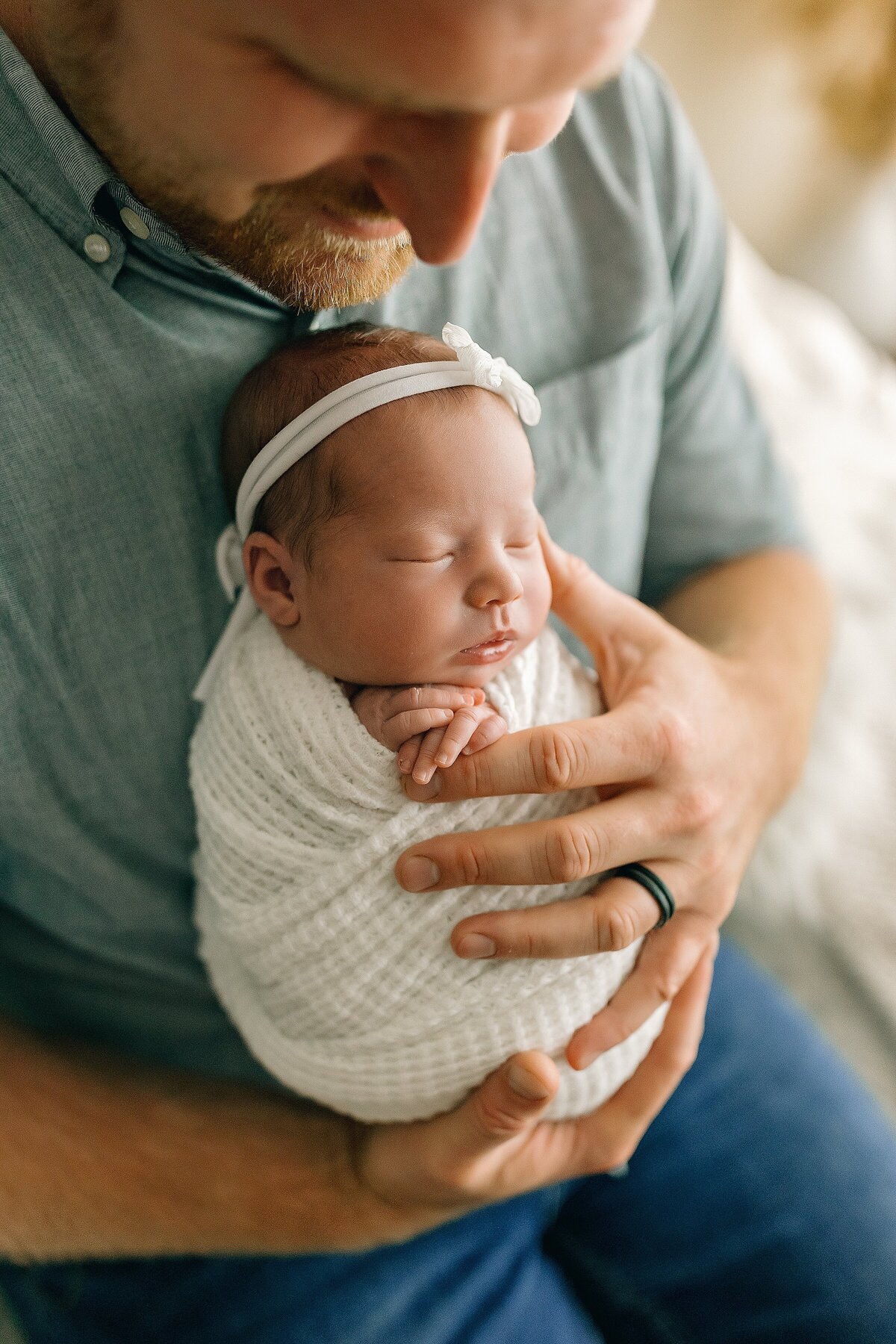 Newborn girl being held by her dad