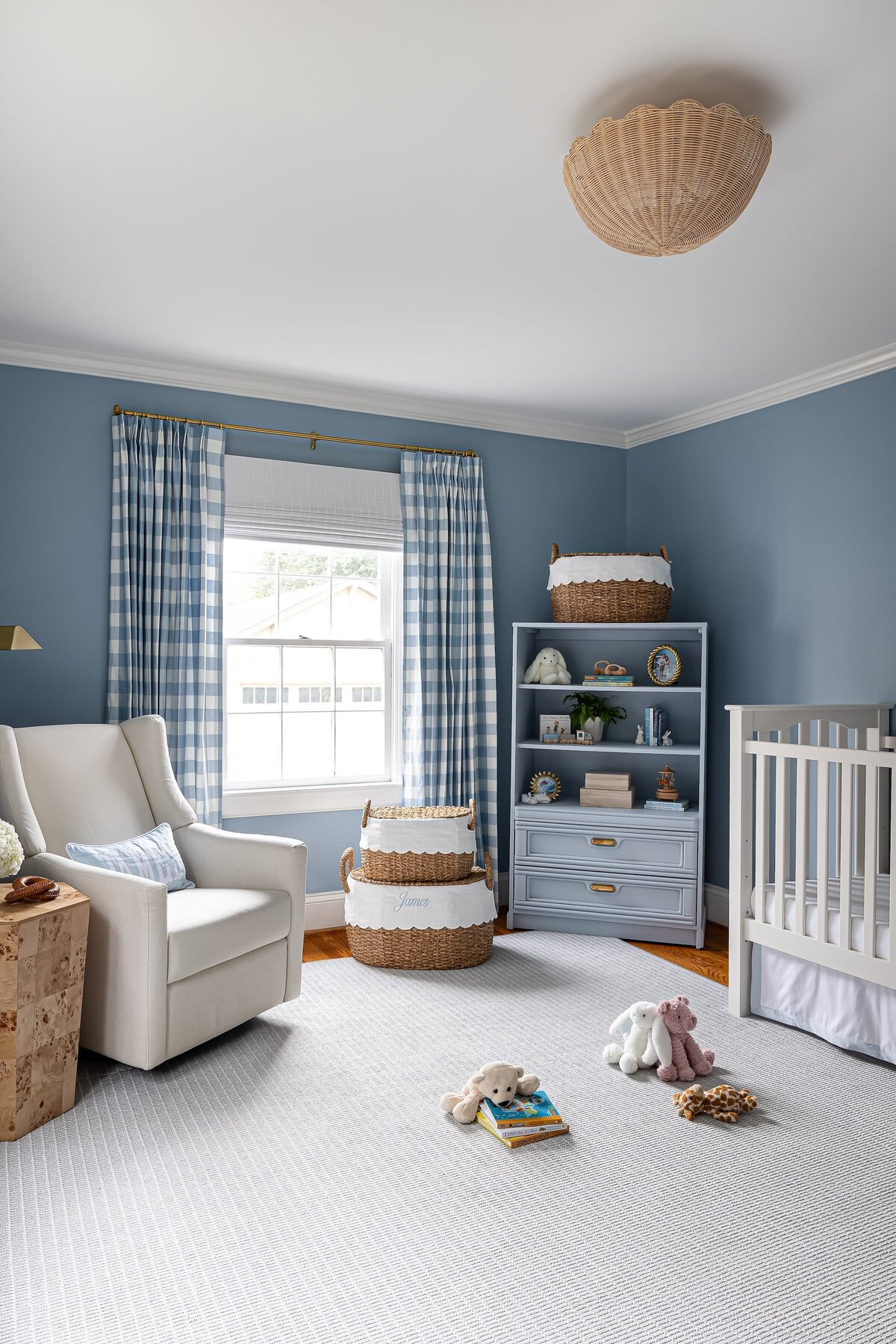 melinda chesson interiors bay street nursery with rocking chair and blue styled shelf