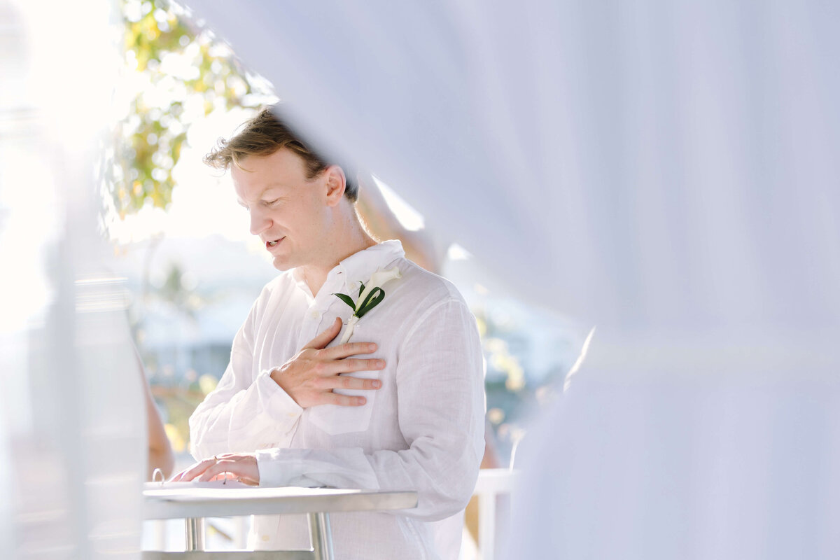 groom in white tux for destination wedding